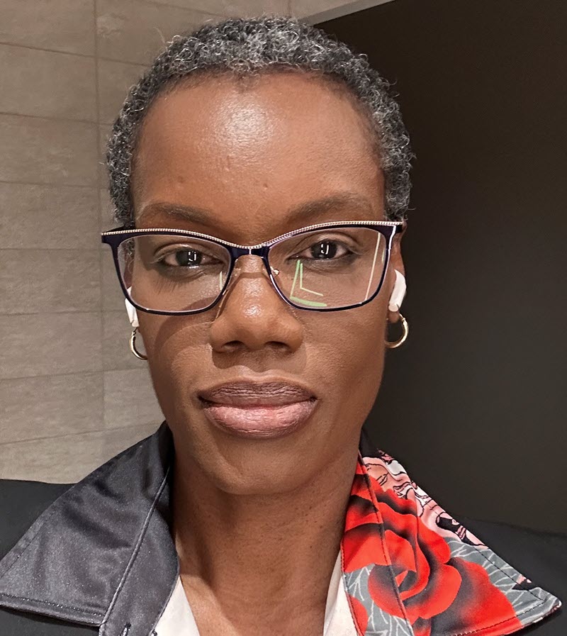 Portrait of Arlene Logan, a professional instructional designer in a plum blouse, looking confident and approachable